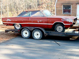 Junker Car on Trailer from High Peak Deception Non-Fiction Novel by Marla Gates